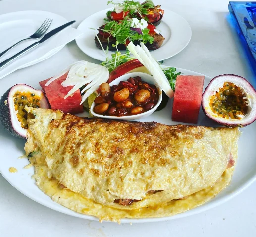 Omelette with beans, watermelon, passionfruit and salad